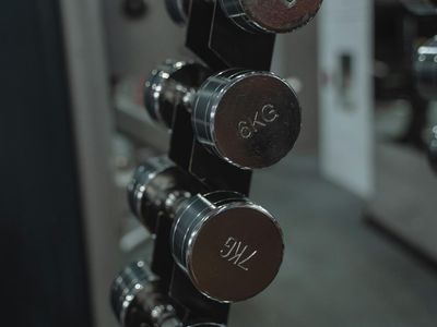 Close up shot of heavy dumbbells on a rack.